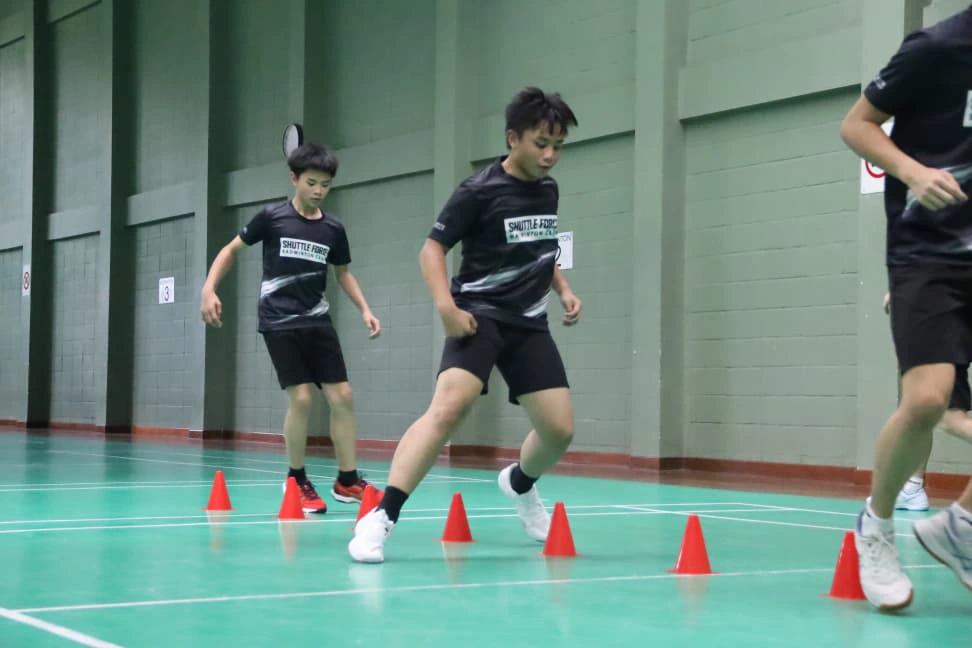 Coach guiding badminton students in Bandar Utama