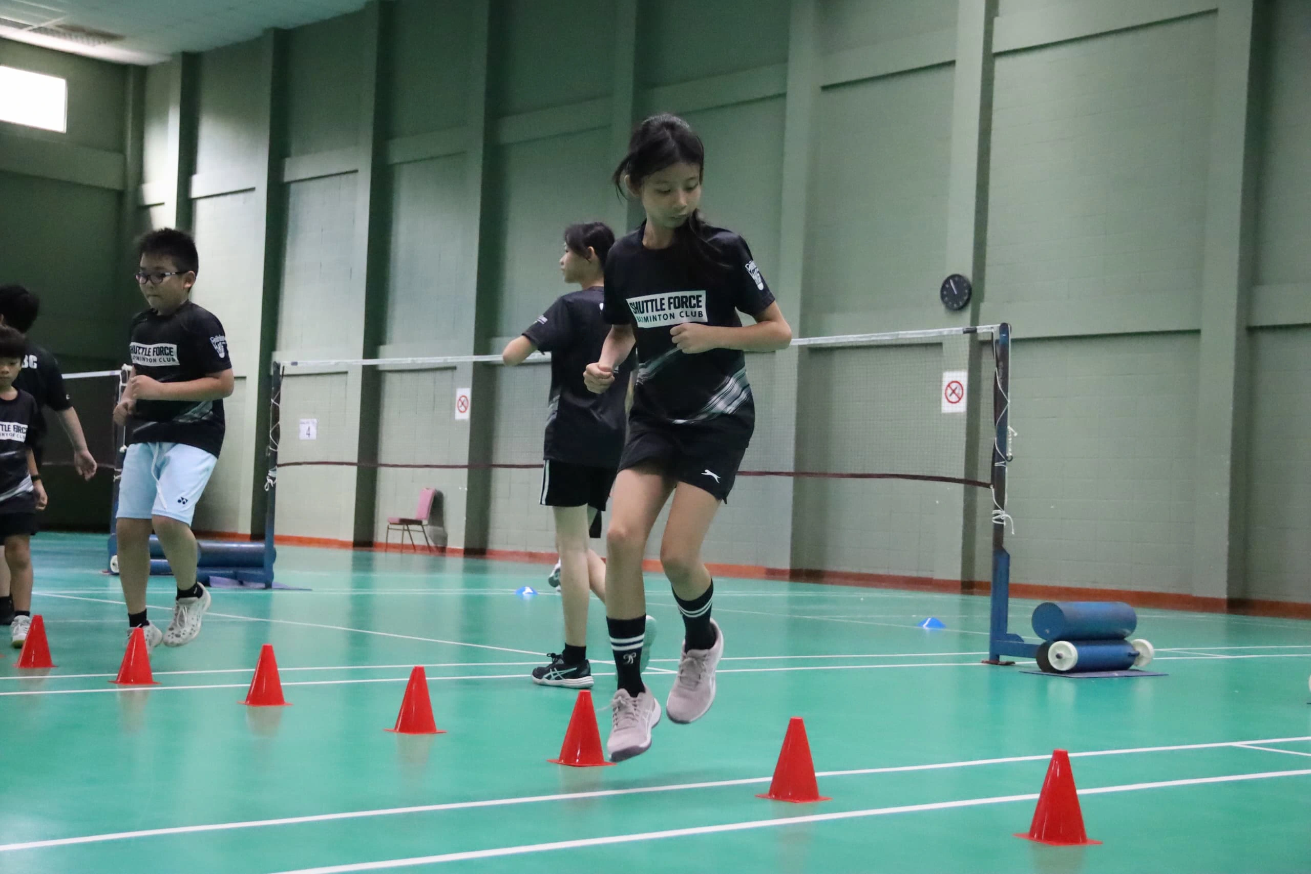 Indoor badminton coaching session at Shuttle Force Badminton Club