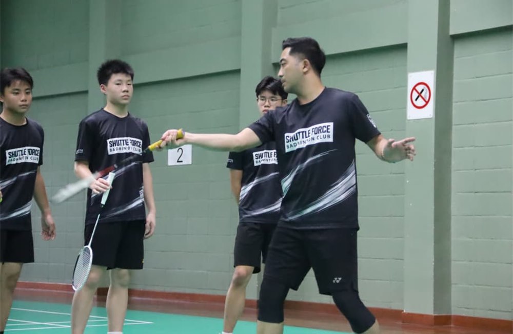 Badminton coach training students at Shuttle Force Badminton Club in Petaling Jaya